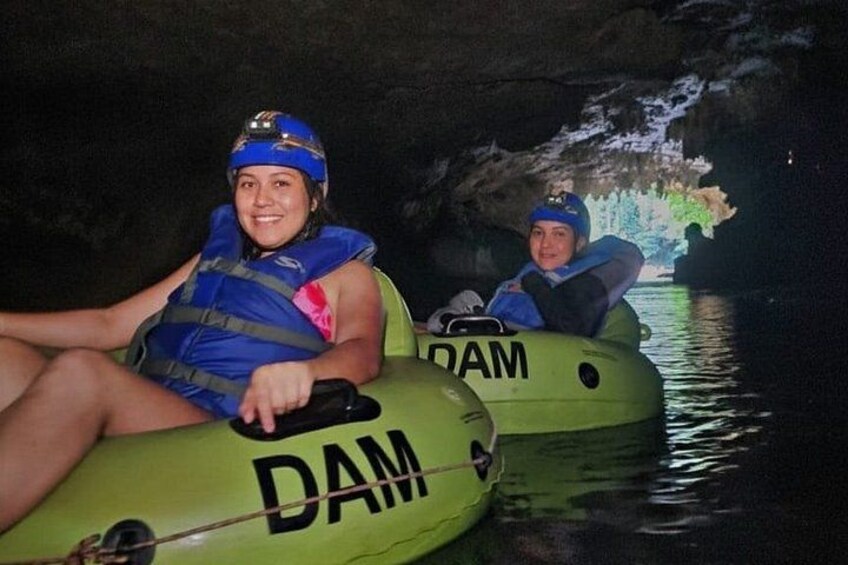 Two people in inflatable rafts labeled 'DAM' on a body of water. 1