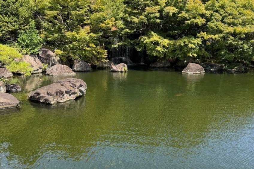 A calm river with rocks and lush greenery. 5