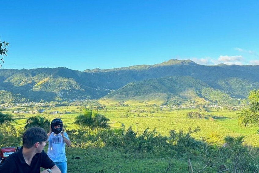 A mountainous landscape with green fields and a clear sky. 1