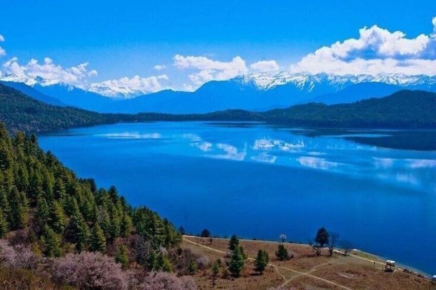 A lake surrounded by mountains and trees. 2