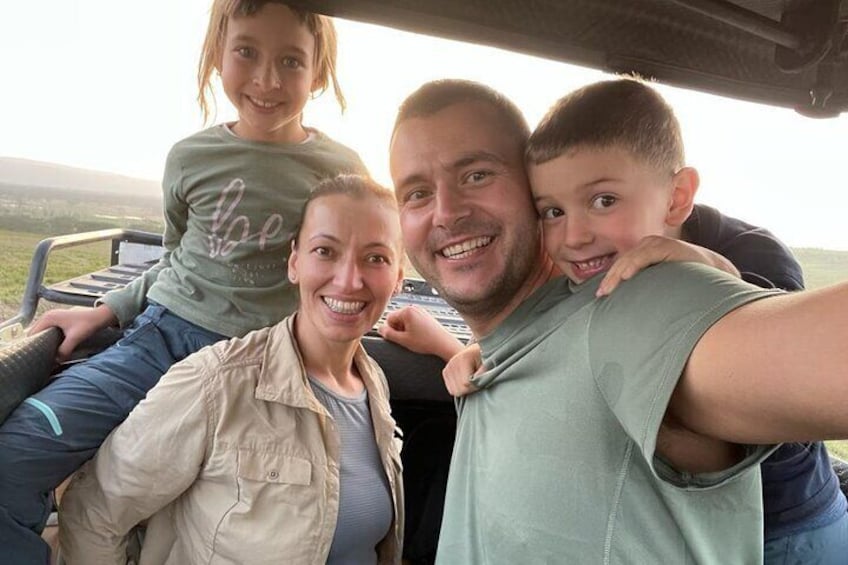A family inside a vehicle with a landscape in the background. 5