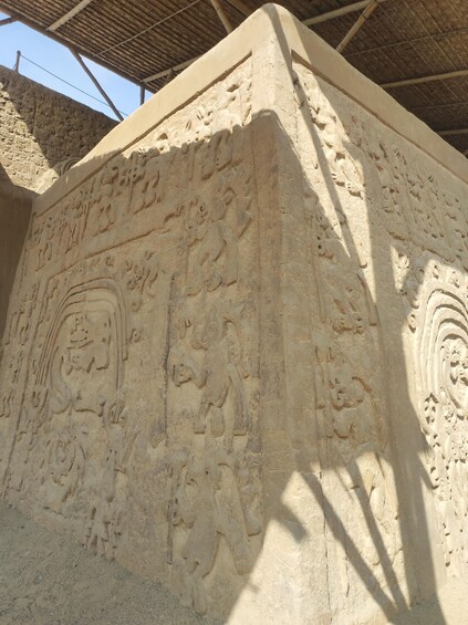 Ancient carved stone architecture with intricate designs and patterns. 1