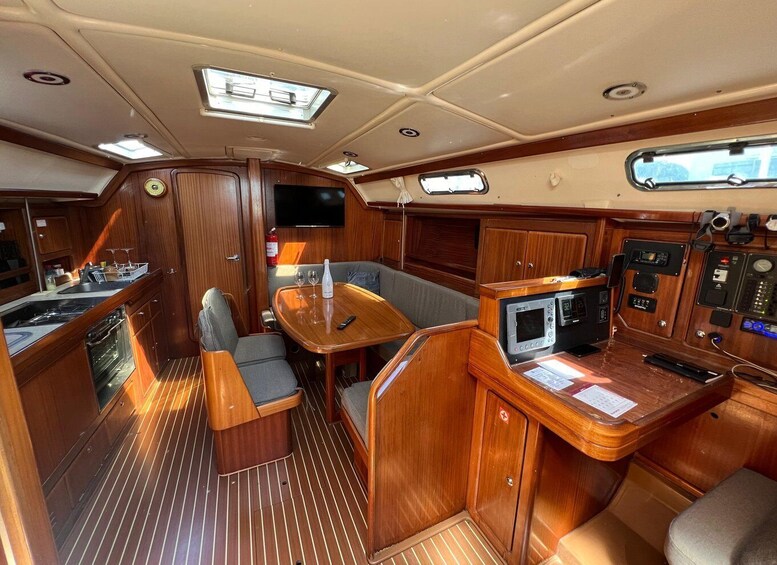 A boat's interior with a kitchen, seating area, and control panel. 4