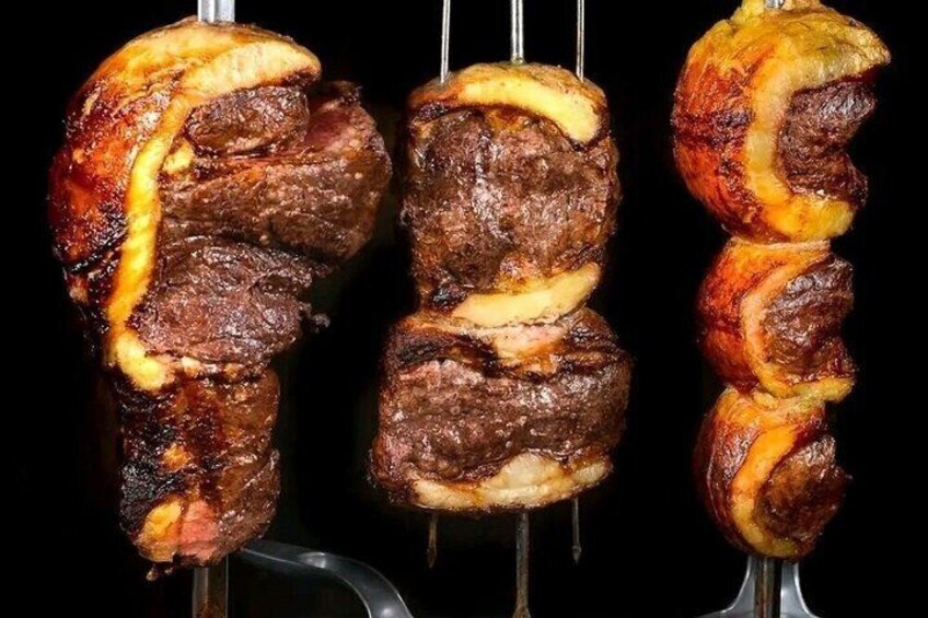 Three skewers of grilled meat with visible char marks. 1