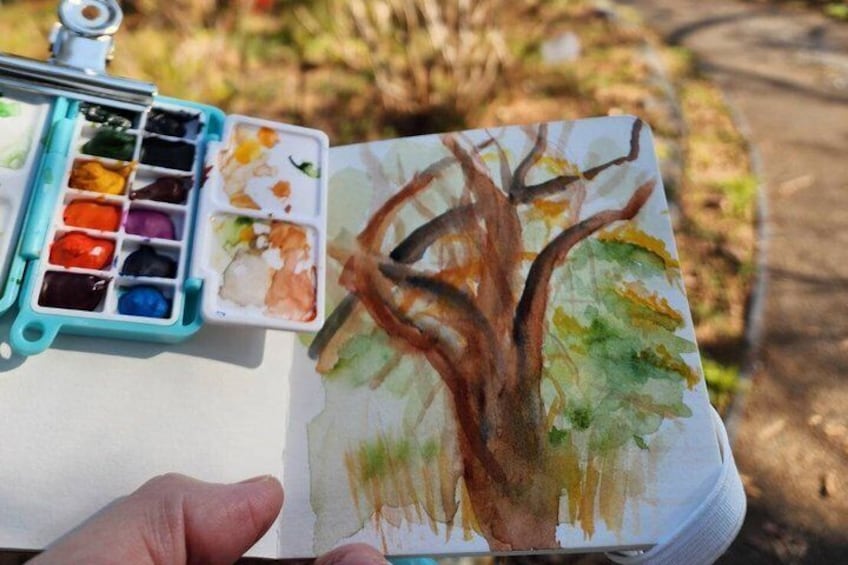 Ein Aquarellgemälde von einem Baum mit einer Staffelei daneben. 5