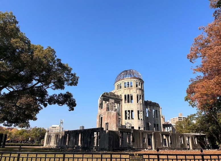 A historic building with a dome, surrounded by trees and a fence. 4