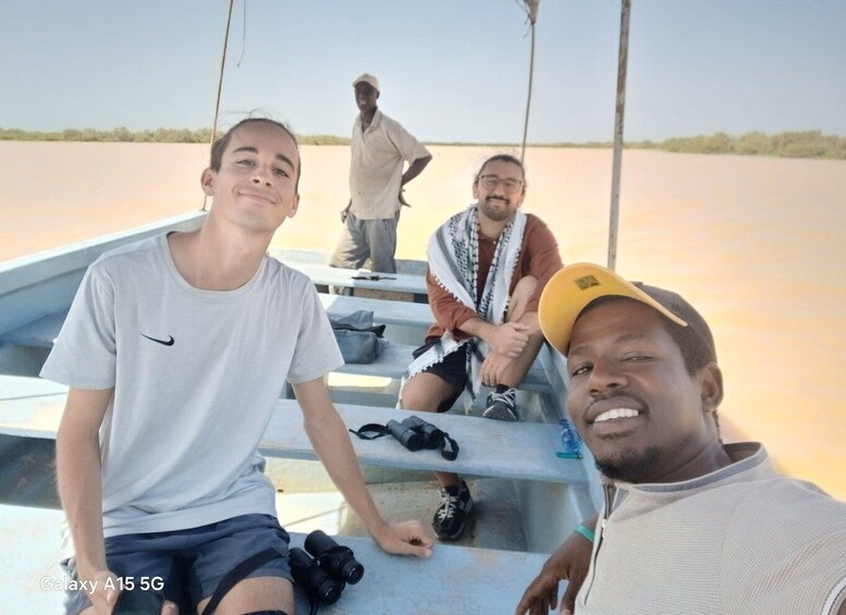 Three people on a boat with a calm water body in the background. 3