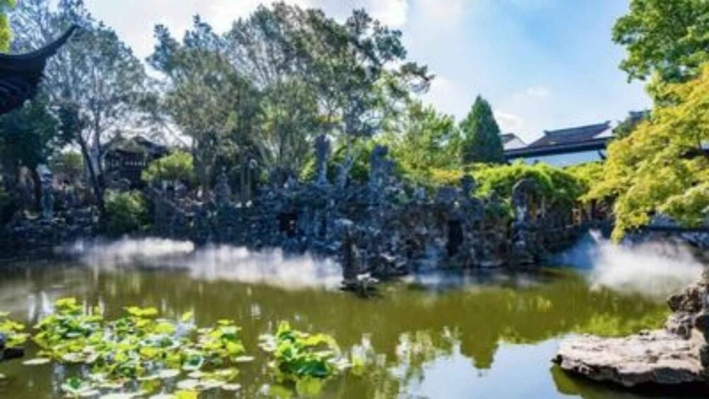 A serene pond with lily pads, surrounded by lush greenery and traditional architecture. 4