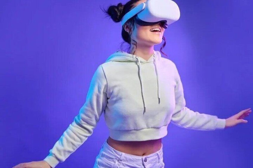 A person wearing a VR headset and a light-colored hoodie. 5