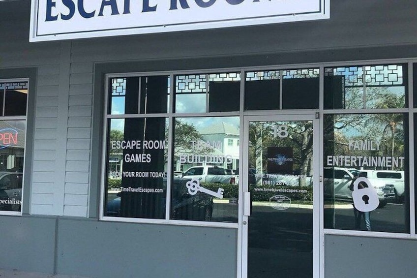 A storefront with large windows advertising 'Escape Room Games' and 'Family Entertainment.' 2