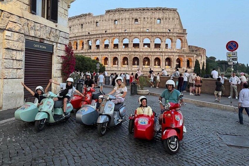 A group of people on scooters in front of the Colosseum in Rome. 3