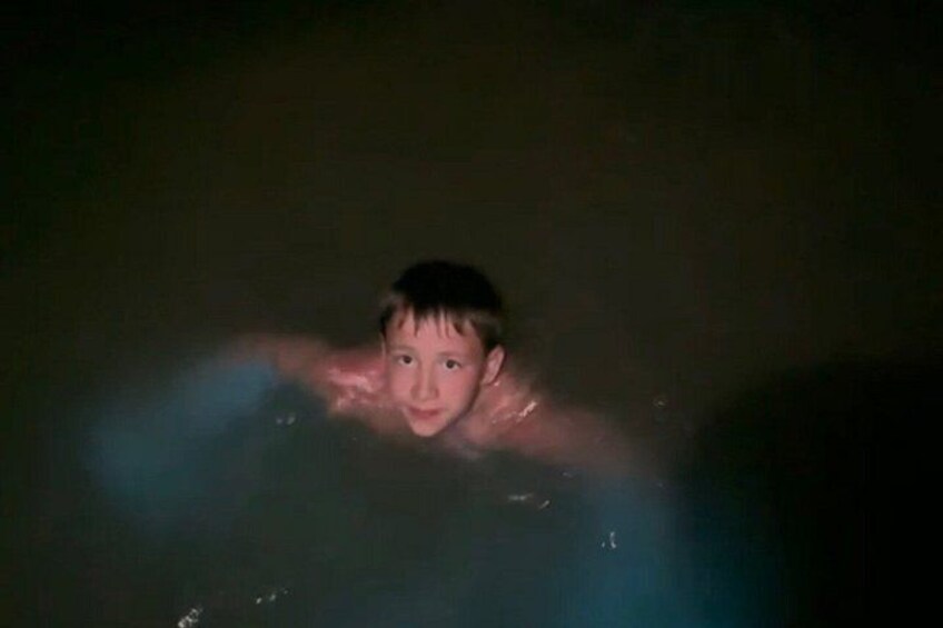 A person in a dark environment, possibly water, with limited visibility. 5