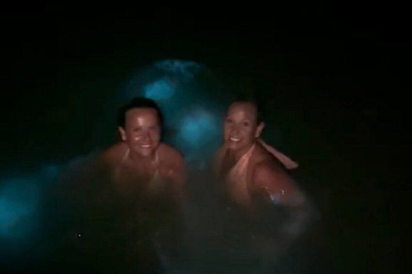 Two people in a hot spring with steam rising around them. 2