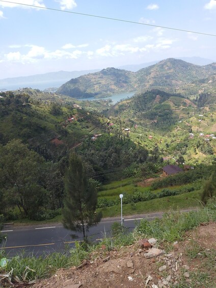 A lush valley with terraced fields, a river, and scattered houses. 1