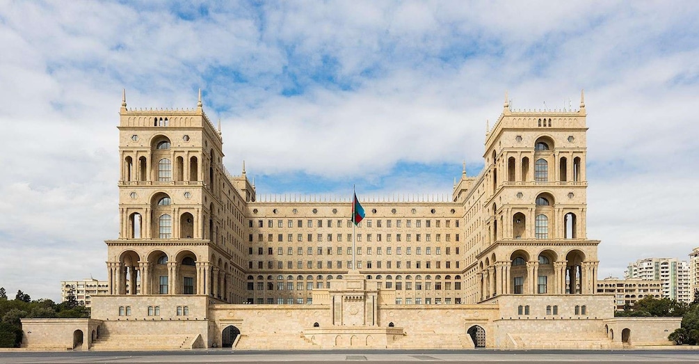 A large, historic building with two symmetrical towers and a central entrance. 4