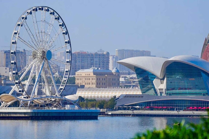 A Ferris wheel, a modern building with a curved roof, and a historic building with domes. 3
