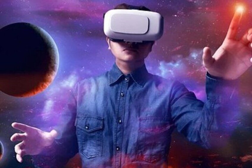 A person wearing a virtual reality headset in a space-themed environment with planets and cosmic elements. 5
