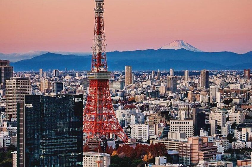 A cityscape with a prominent red tower, a mountain in the background, and a mix of modern and traditional buildings. 1