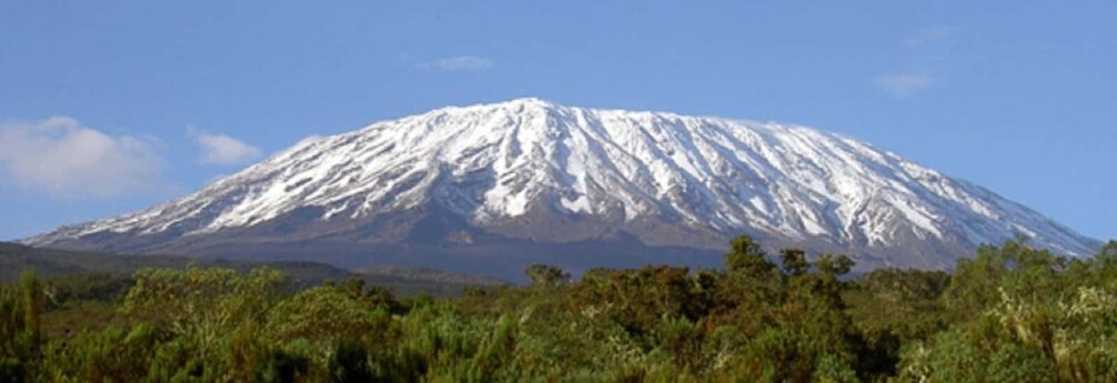 A snow-capped mountain with a clear sky. 1