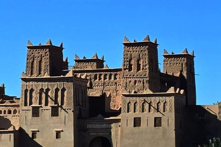 A large, historic building with multiple towers and intricate architectural details. 5