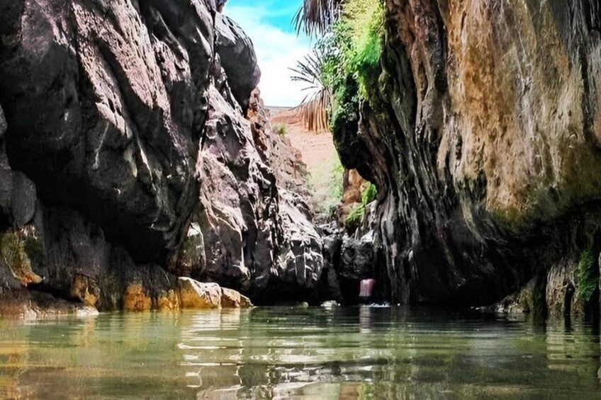 A rocky canyon with a river flowing through it. 4
