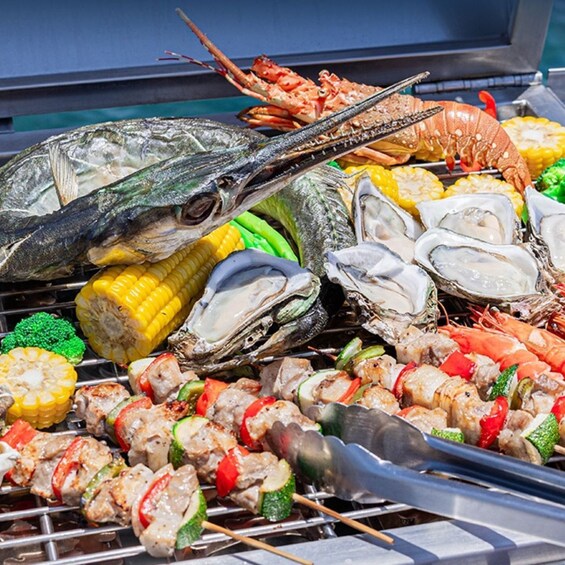 A variety of seafood and grilled vegetables on a grill. 2