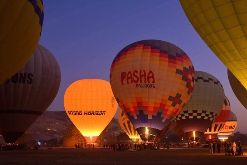 Hot air balloons with visible company names like 'Pasha Balloons' and 'Skyline Horizon' against a twilight sky. 4