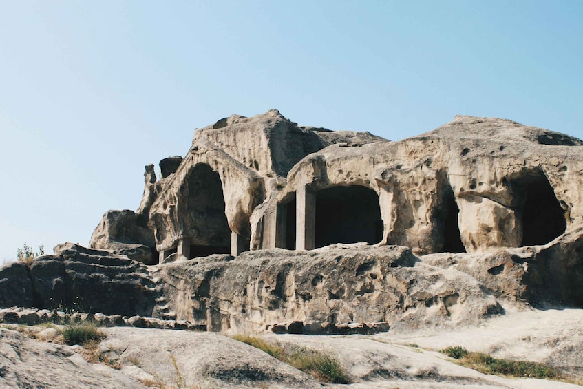 Ancient rock-cut architecture with columns and arches. 3