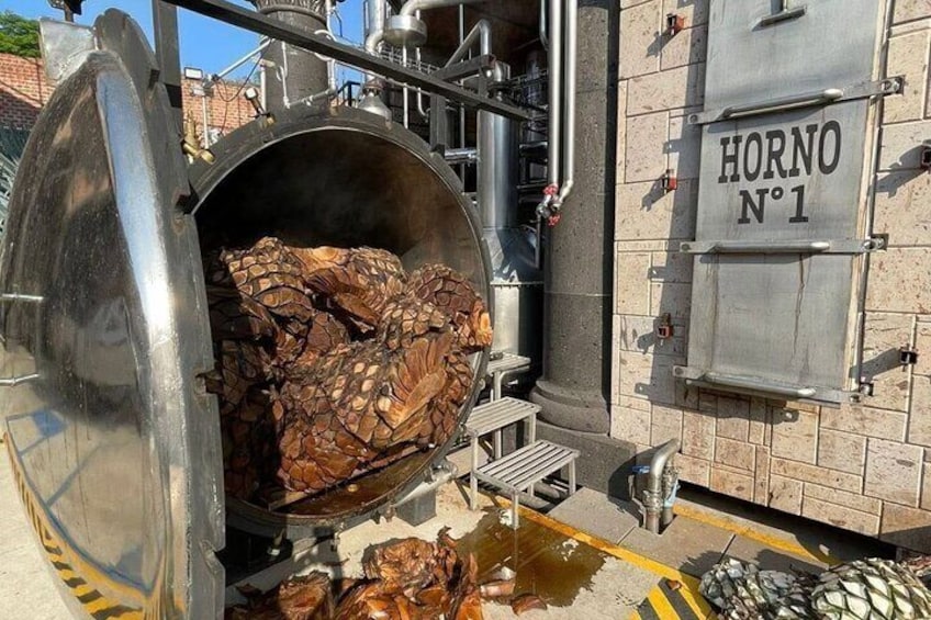 A large industrial oven with wood inside, labeled "HORNO N°1". 4