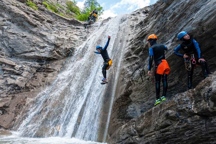 A person rappelling down a waterfall. 1