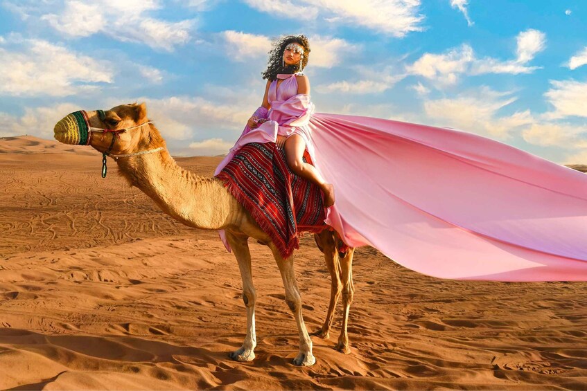 A person riding a camel in a desert landscape. 5