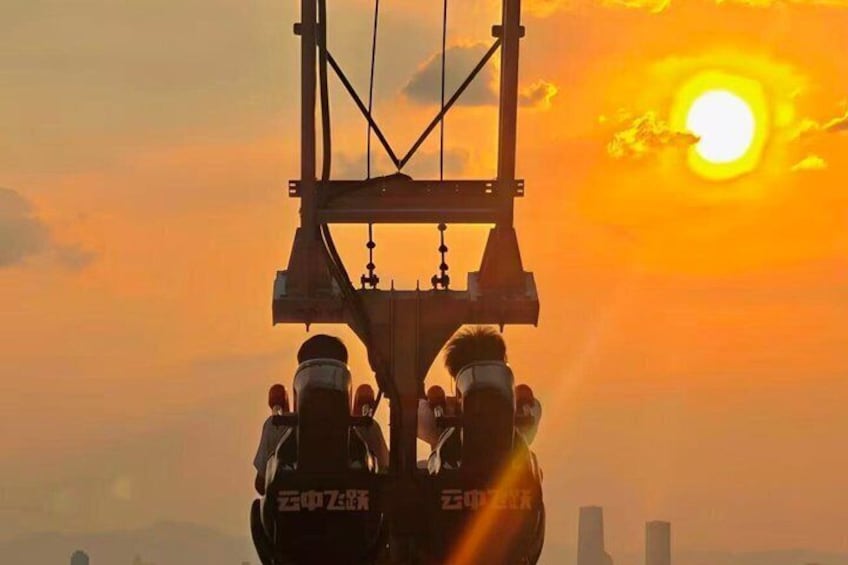 A crane lifting a heavy load against a sunset sky. 4