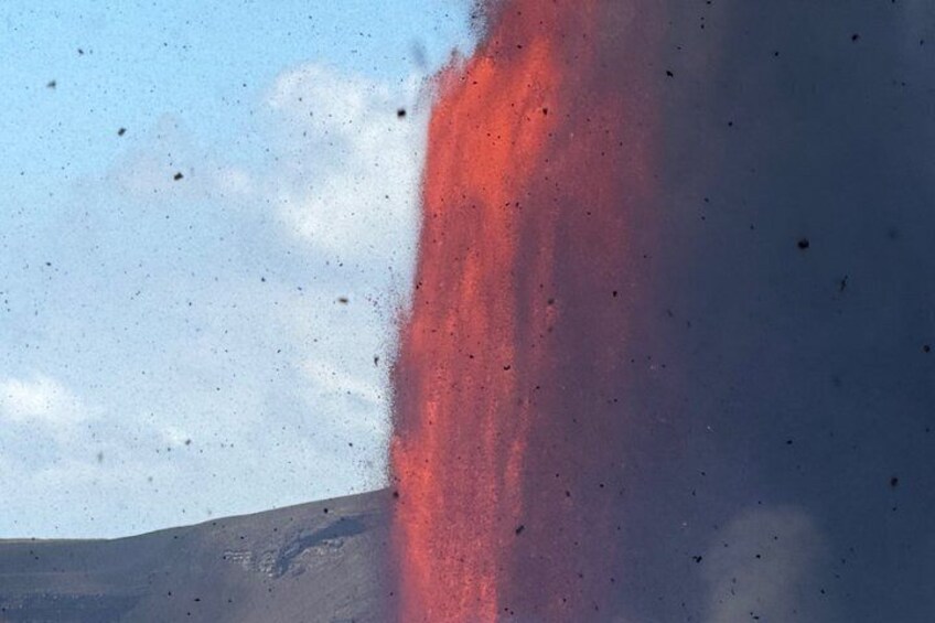 A red plume of smoke against a clear sky. 3