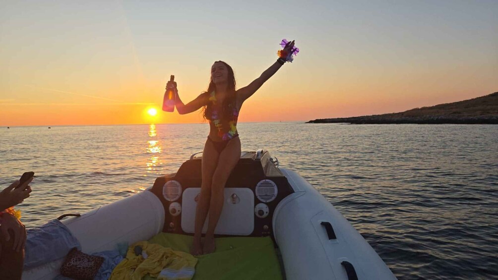A person on a boat at sunset with the sun reflecting on the water. 1