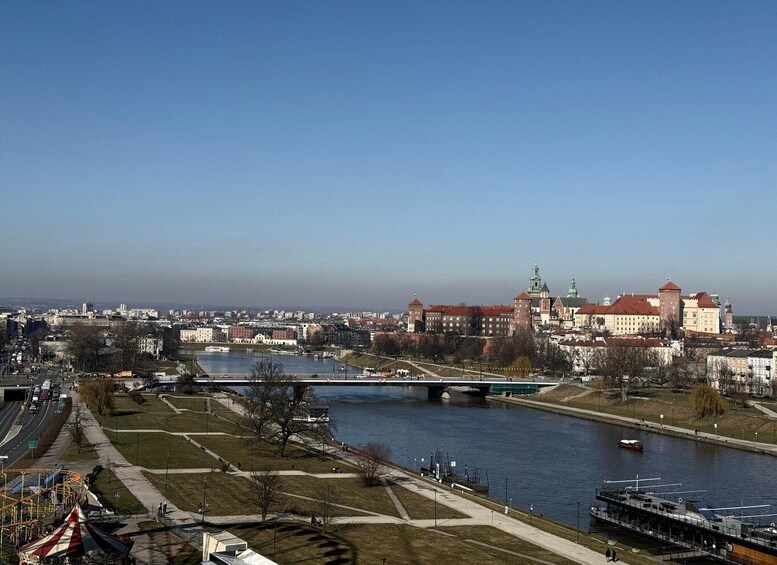 A river with a bridge, a park, and historic buildings in the background. 4
