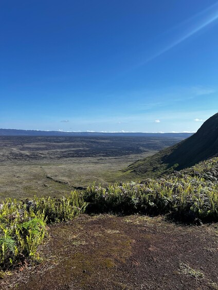 A mountainous landscape with a clear sky and distant snow-capped peaks. 5