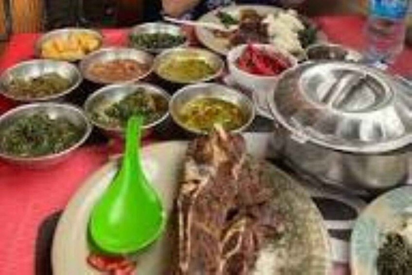 A variety of dishes and a large pot on a table. 2