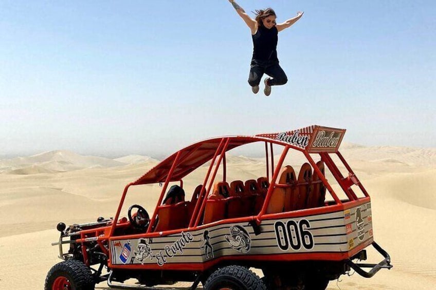 En sandbuggy med en ökenlandskap i bakgrunden. 1