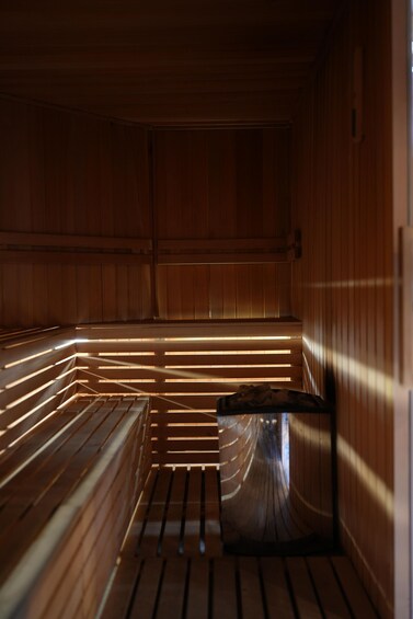 A sauna with wooden benches and slatted walls. 3
