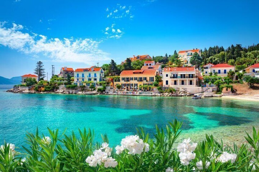 A coastal village with colorful houses, clear turquoise waters, and lush greenery. 1