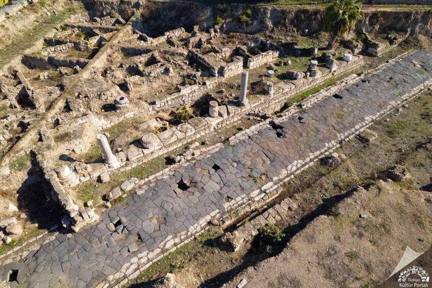 Ancient ruins with stone pathways and columns. 1