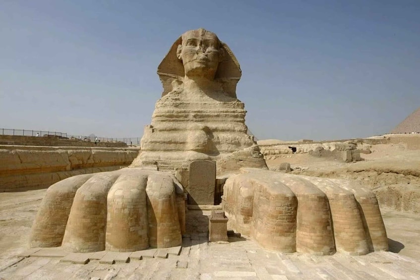 The Great Sphinx of Giza with its iconic lion head and outstretched arms, set against a clear sky. 3