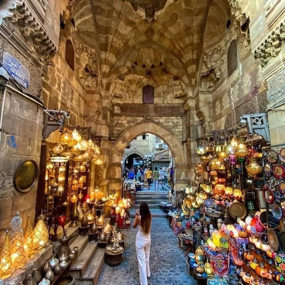 An indoor market with ornate lanterns and pottery. 1