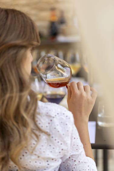 A person holding a wine glass. 3