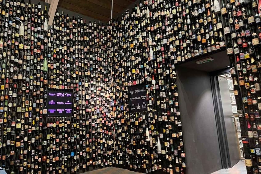 A wall of numerous liquor bottles, some with labels facing forward. 5