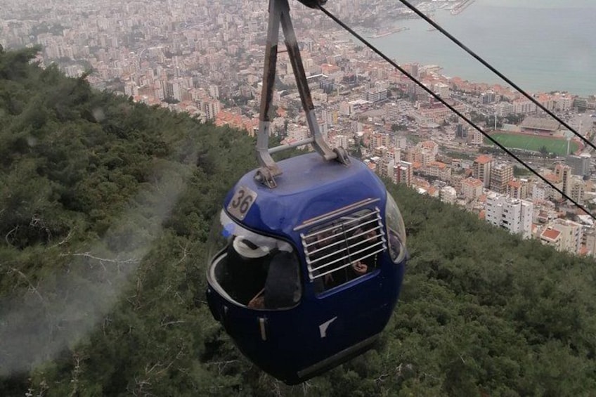 A cable car suspended above a cityscape. 4