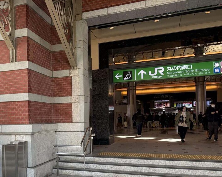 A train station entrance with a sign for JR Marunouchi South. 4