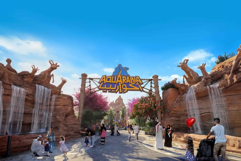 A family at an entrance with a sign that reads 'Aquarabi.' 5