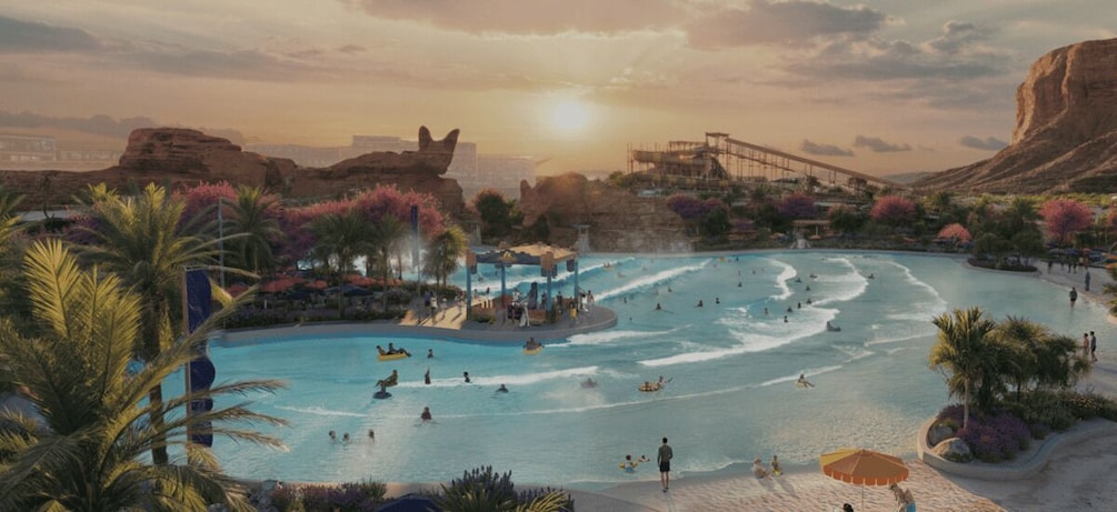 A large outdoor swimming pool with people swimming and lounging, surrounded by palm trees and desert landscape. 2