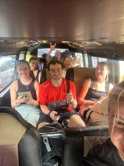 A group of people seated inside a vehicle. 1